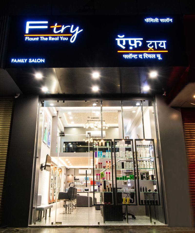 The Ftry Salon shopfront on Dhole Patil Farm Road at night, its lit sign reading Ftry, Flaunt The Real You, Family Salon.